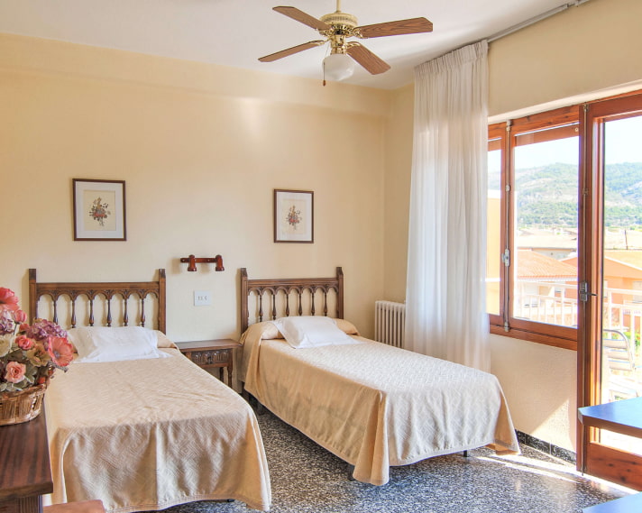 Double Room_Cream Beds Two separate beds, with cream bedspreads and wooden headboards