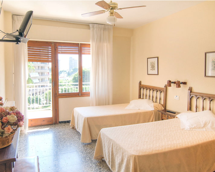 Double Room_Cream Beds 2 Two separate beds, with cream bedspreads and wooden headboards