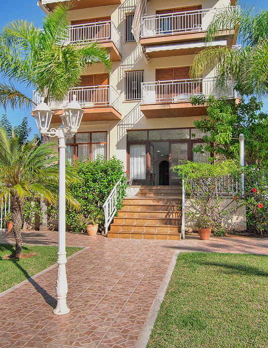 Reception Access to the hotel reception through a garden area.